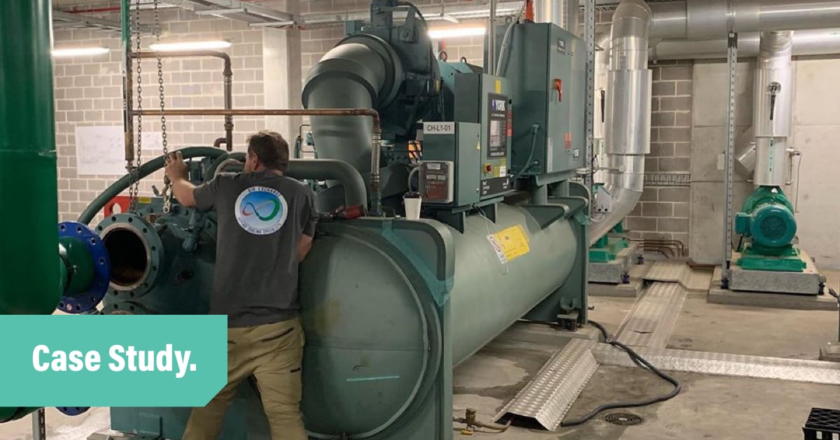 Air Exhange employee works on an industrial sized chiller unit