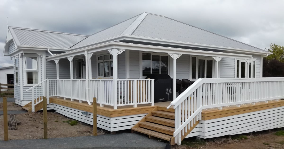 Apex Construction home renovation of a wrap around deck on a beautiful light grey villa