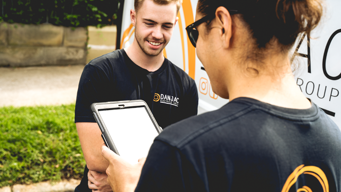 over the shoulder image of two man looking at device