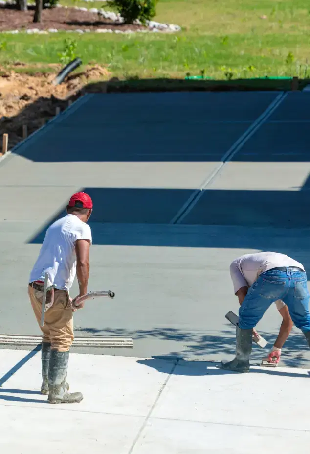 Two men laying concrete