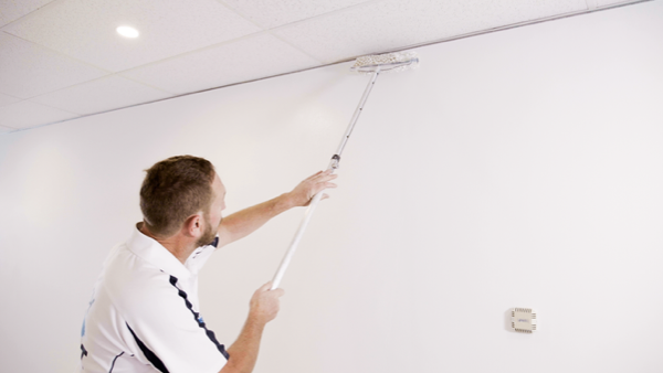 Customer Story_Ready Set Paint_painter in white t-shirt painting a white wall