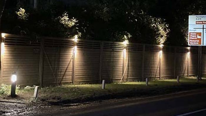 at night shot of garden with downlights on brick wall