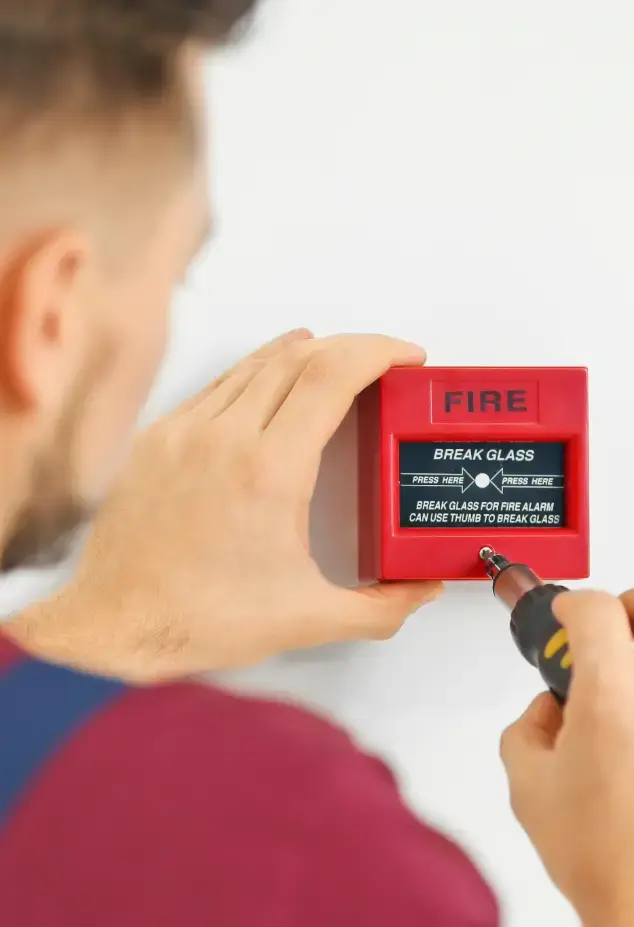 Man installing a fire alarm 