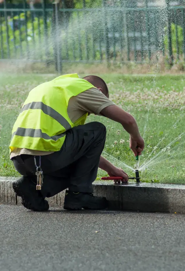 Man fixing irrigation sprinkler system