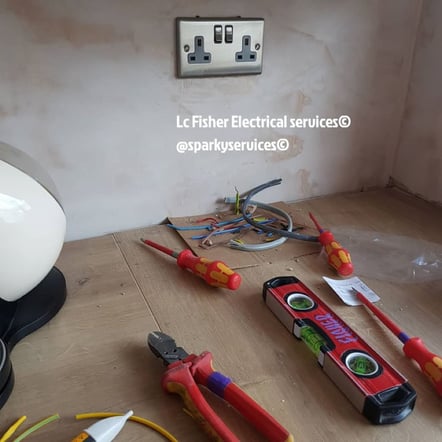 A photo of a newly installed silver coloured double power point with red tools on the floor