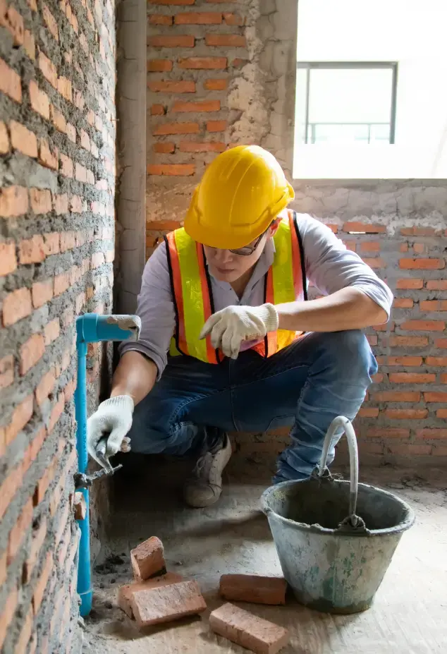 Man working on a brick wall 