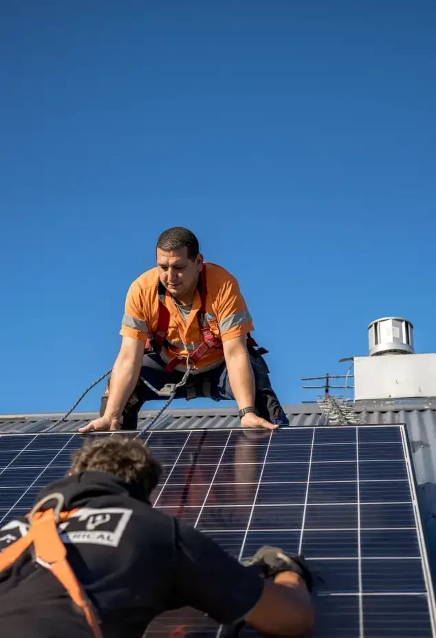 Solar installer installing a solar panel